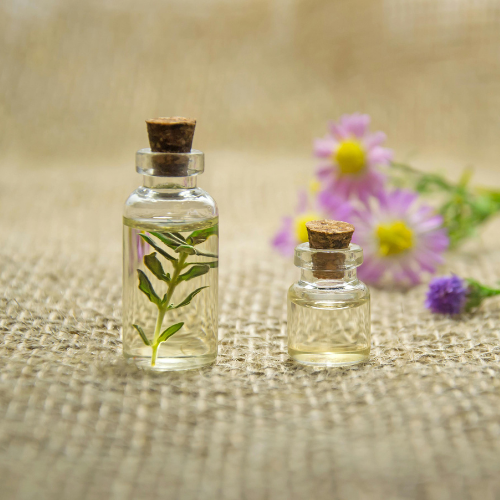 Two glass vials with herbs and fragrant oils.